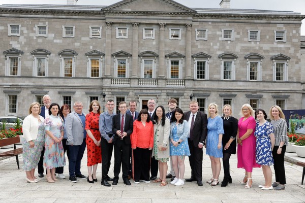 The OWL graduates pictured on the plinth of Leinster House with staff involved with the Houses of the Oireachtas OWL programme