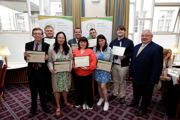 The Ceann Comhairle pictured at the 2023 OWL programme graduation ceremony with the graduates, who are holding their cerficates of completion