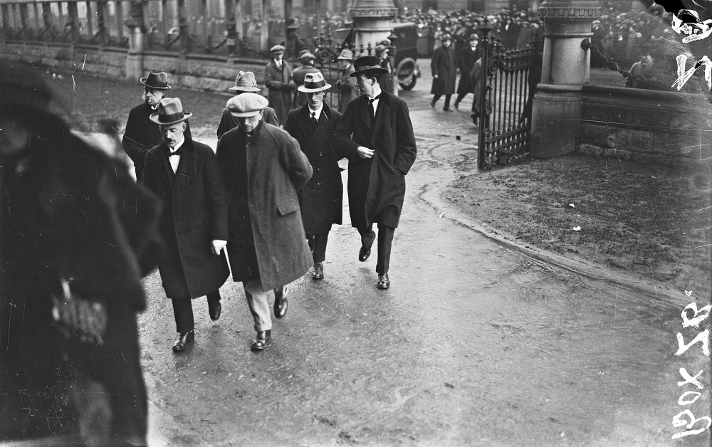 Photograph of people walking through gates, 1921 or 1922