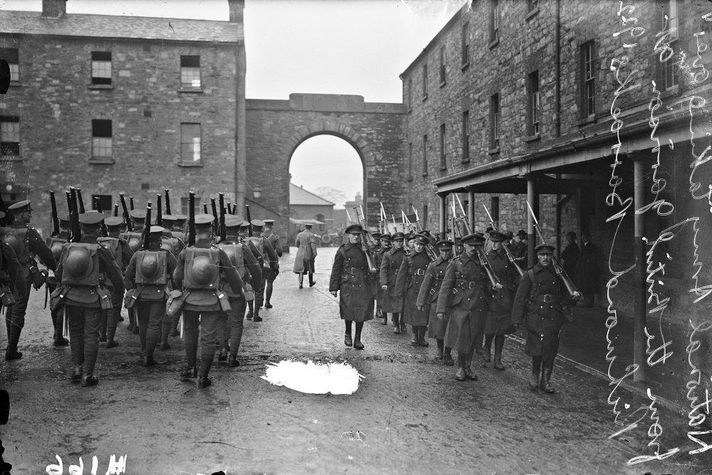 Soldiers marching outside a barracks gate 1922