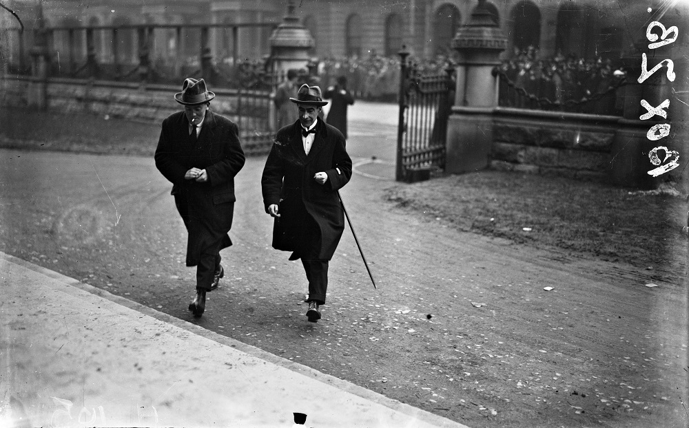 Two men walking through gates 1921 or 1922