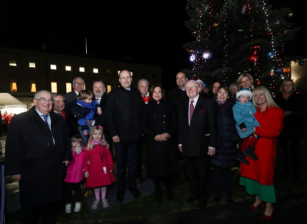 Oireachtas members with their families at the lighting of the Christmas tree on Leinster Lawn by night