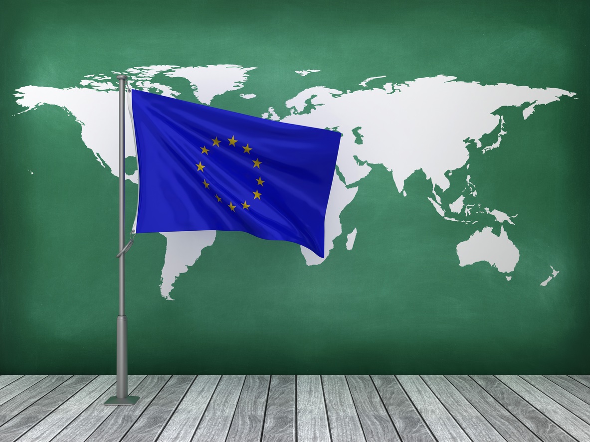 European Union flag in front of green map of the world