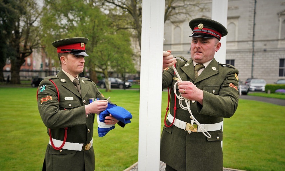 Members of the Defence Forces raise the EU flag on Leinster Lawn