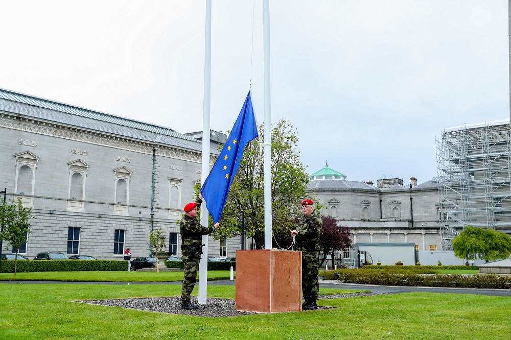 Members of the Defence Forces raising the EU flag outside Leinster House