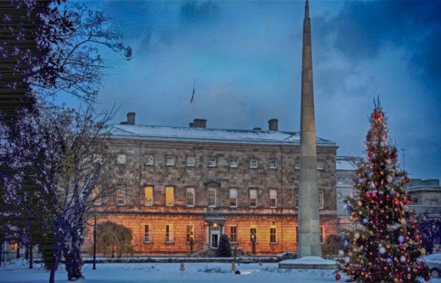 Exterior shot of Leinster House in winter around Christmas time with snow apparent and a Christmas tree in the shot
